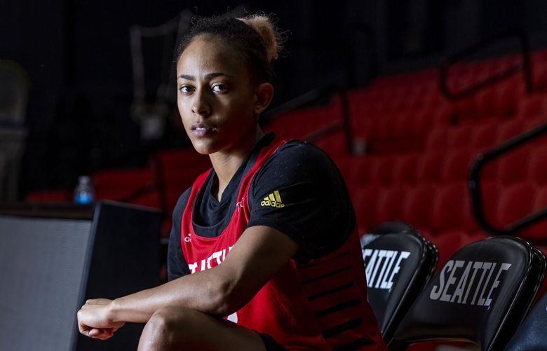 Seattle University women’s basketball player Bree Calhoun sits on the sidelines at the basketball court at Seattle University’s Redhawk Center on Friday, Oct. 29, 2021. 218640