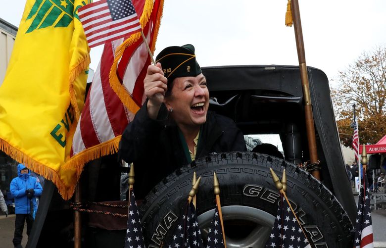 Former Women’s Army Corps (WAC) member Monica Grosman (CQ) loves a parade and waves from the back of a flag-adorned vehicle in the 56th Annual Veterans Day parade in Auburn, Washington on Saturday.  

REF to more photos online

Saturday Nov. 6, 2021 218744