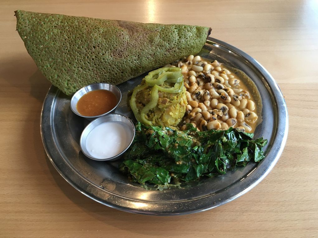 A kale-infused dosa plate at The Sudra, with black-eyed pea korma and other delicious stuff, is one of many deeply satisfying vegan meals available in the Rose City. (Brendan Kiley / The Seattle Times)