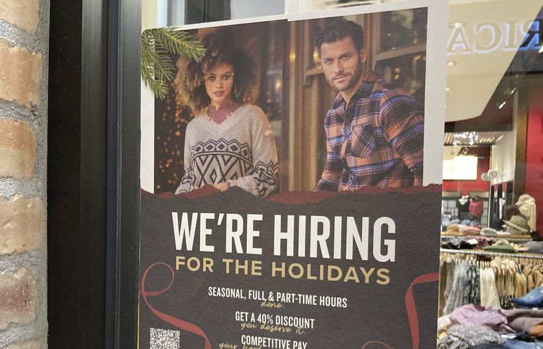 A hiring sign hangs in the window of a clothing store in Colorado Mills Mall Monday, Nov. 8, 2021, in Lakewood, Colo. (AP Photo/David Zalubowski) 