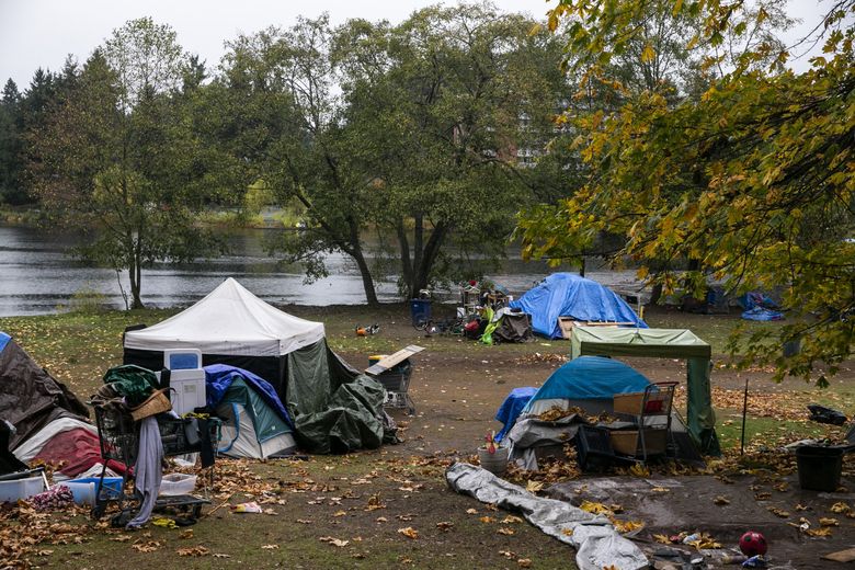 More than 60 people are living at an encampment at Bitter Lake in North Seattle that has been growing for more than a year. King County bought a motel nearby, which will house some of the people living at the site. 
(Amanda Snyder / The Seattle Times, File)