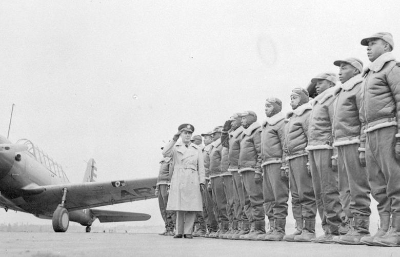 FILE – Major James A. Ellison, left, returns the salute of Mac Ross of Dayton, Ohio, as he inspects the cadets at the Basic and Advanced Flying School for Black United States Army Air Corps cadets at the Tuskegee Institute in Tuskegee, Ala., in Jan. 23, 1942. For Veterans Day, a group of Democratic lawmakers is reviving an effort to pay the families of Black servicemen who fought on behalf of the nation during World War II for benefits they were denied or prevented from taking full advantage of when they returned home from war. (AP Photo/U.S. Army Signal Corps, File) CER501 CER501