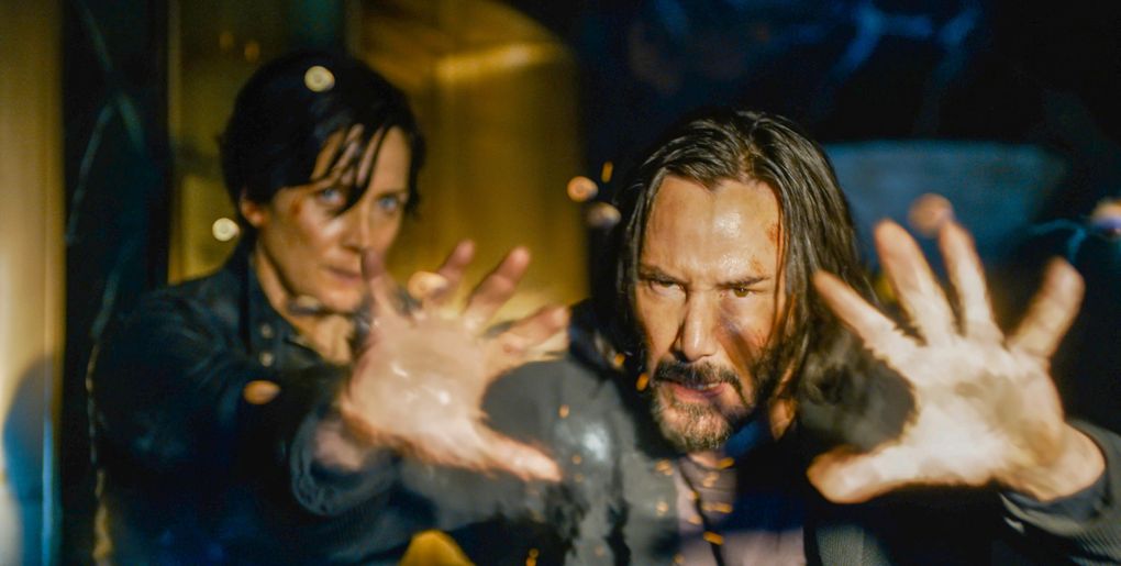 Carrie-Anne Moss as Trinity and Keanu Reeves as Neo/Thomas Anderson in “The Matrix Resurrections.” (Warner Bros. Pictures)