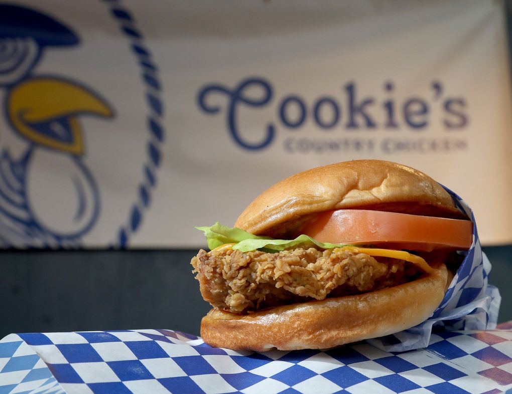 Cookie's Country Chicken Signature Sandwich pairs fried chicken with iceberg lettuce, tomato, cheese and sunny gravy.  The popular pop-up that debuted during the pandemic in Pioneer Square has found a permanent home in the former Golden Beetle space in Ballard.  (Greg Gilbert / The Seattle Times)