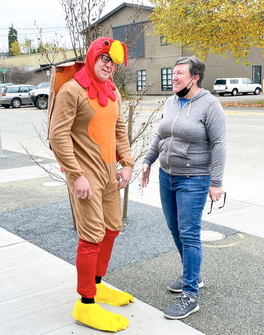 Chef Ethan Stowell, whose restaurant group Ethan Stowell Restaurants sponsors the Seattle Turkey Trot, dressed up as a turkey with Ballard Food Bank executive director Jen Muzia. (Courtesy of Colleen Martinson)