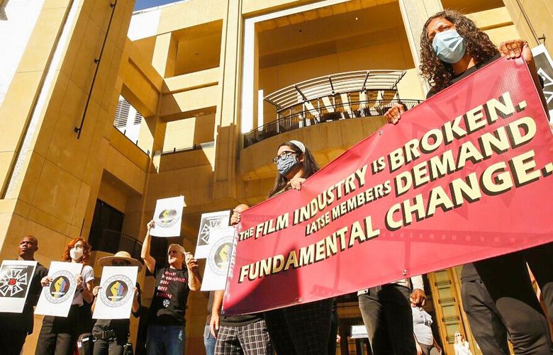 LOS ANGELES, CA – NOVEMBER 11: Camile Lewis, right, with Skye Smith, left, both activists with the Sunrise Movement join International Alliance of Theatrical Stage Employees (IATSE) members and Entertainment Industry Worker Supporters during a press conference outside the Dolby Theatre in Hollywood Thursday afternoon calling for 'Fundamental Changes in the Entertainment Industry to protect workers'. The group says that in spite of incremental changes over the years, the contracts have still failed to keep us safe on set. IATSE members are voting on whether to ratify a new contract this weekend, and many are undecided. Dolby Theater Hollywood on Thursday, Nov. 11, 2021 in Los Angeles, CA. (Al Seib / Los Angeles Times). 32327255P