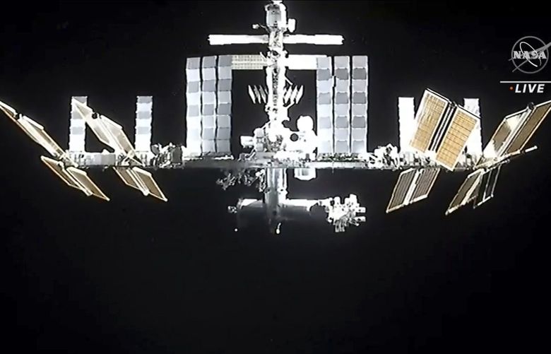 In this image from video provided by NASA, the International Space Station is seen as astronauts in the SpaceX Dragon capsule undock on Monday, Nov. 8, 2021, (NASA via AP) NY112 NY112
