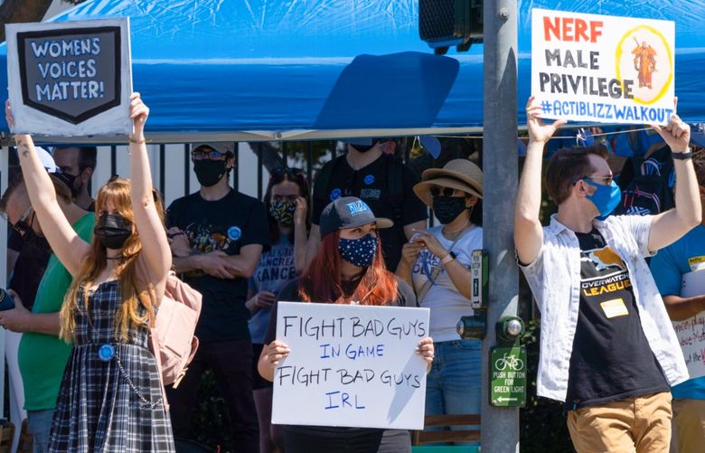 Employees hold up signs on Blizzard Way during a walkout at Activision Blizzard offices in Irvine, California, U.S., on Wednesday, July 28, 2021. Activision Blizzard Inc. employees called for the walkout on Wednesday to protest the company’s responses to a recent sexual discrimination lawsuit and demanding more equitable treatment for underrepresented staff. Photographer: Bing Guan/Bloomberg 775688068