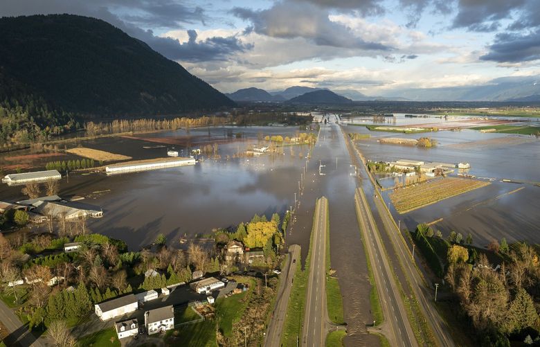Floodwaters cover Highway 1 in Abbotsford, British Columbia, Tuesday, Nov. 16, 2021. (Jonathan Hayward/The Canadian Press via AP) JOHV153 JOHV153