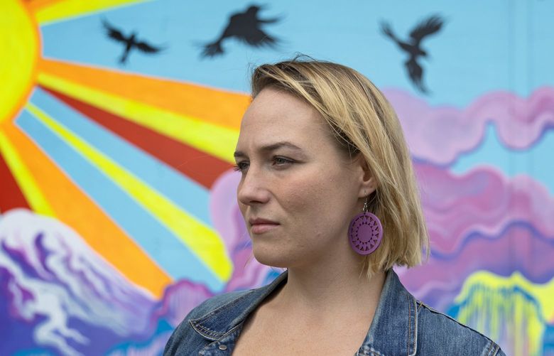 Tara Velan, a Seattle-based freelance artist, Wednesday, Sept. 22, 2021 is seen with a mural she painted in the city. Velan filed a report to the police in July 2016 alleging she had been sexually assaulted by her massage therapist and later was astonished that the massage therapist had been allowed to practice after the Department of Health became aware of the first complaint. Velan felt her assault was preventable. 218254