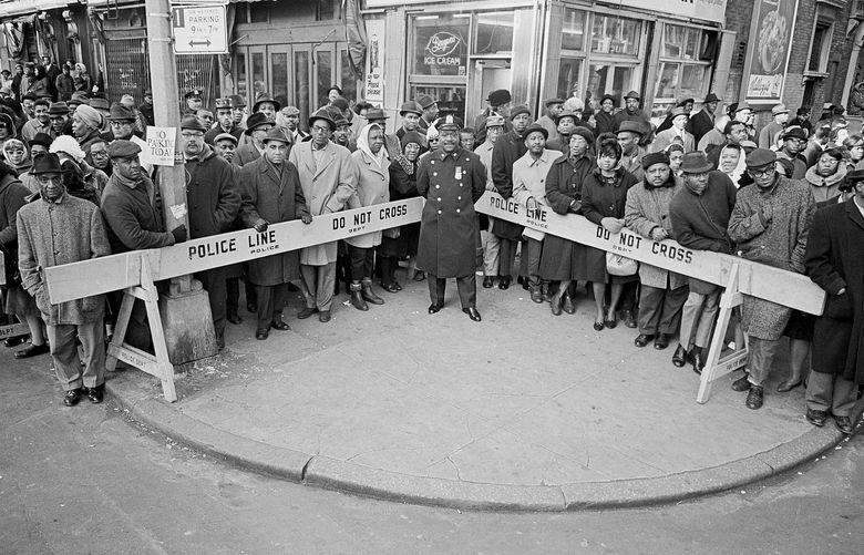 FILE — People gather in hopes of glimpsing Malcolm Xâ€™s coffin after his funeral in the Harlem neighborhood of New York, Feb. 27, 1965. Malcolm X was assassinated six days earlier. For decades, the killing of Malcolm X has captivated the attention of scholars with a critical question: Were the wrong men convicted of the crime? (Don Hogan Charles/The New York Times) XNYT128 XNYT128