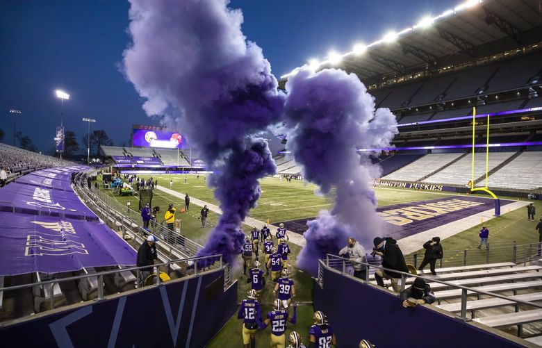 HUSKIES FILE

Players take the field through purple smoke as the University of Washington Huskies take on the Utah Utes at Husky Stadium in Seattle Saturday November 28, 2020. 215768