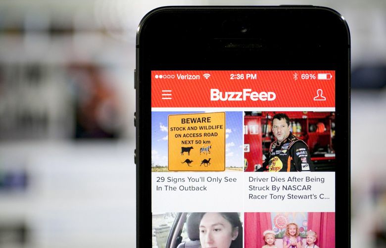 The Buzzfeed Inc. application (app) is displayed on an Apple Inc. iPhone 5s in this arranged photograph in Washington, D.C., U.S., on Monday, Aug. 11, 2014. BuzzFeed Inc. raised $50 million on a bet its mix of everything from animal lists to serious news is more valuable than the coverage produced by established media like the Washington Post and Los Angeles Times. Photographer: Andrew Harrer/Bloomberg 506701793