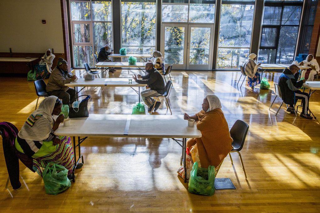 Members of the East African community come together for a meal at Northgate Community Center. The program offers culturally familiar and nutritious food.
(Daniel Kim / The Seattle Times)