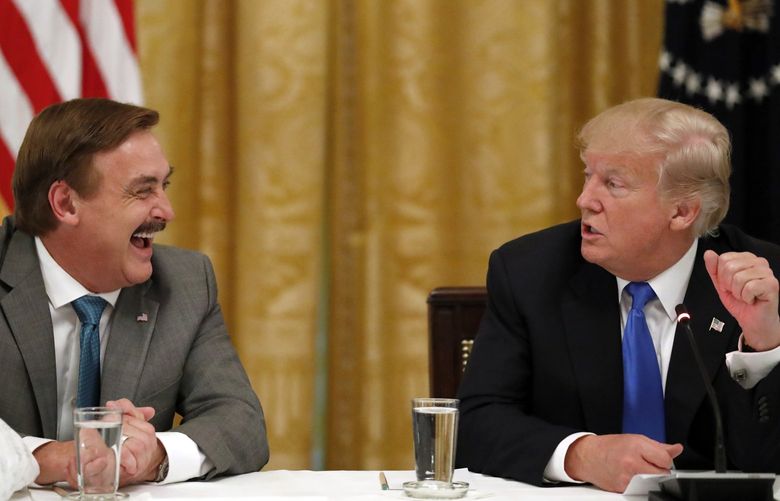 Michael Lindell, with My Pillow, laughs with President Donald Trump during a “Made in America,” roundtable event in the East Room of the White House in Washington, Wednesday, July 19, 2017. (AP Photo/Alex Brandon)