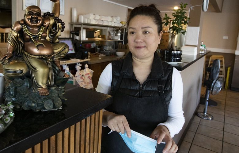 Co-owner Yong Hong Wang of Seven Stars Pepper, Wednesday, Nov. 17, 2021 in Seattle’s International District, says the unending loitering and street crime outside her Szechuan restaurant has devestated business. 218805