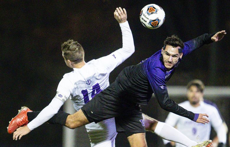 Washington midfielder Gio Miglietti (8) and Portland defender Brian O’Hara (14) fight for the ball in the air during the second round of the NCAA tournament at Husky Soccer Stadium on Sunday, Nov. 21, 2021. Huskies won 3-1.