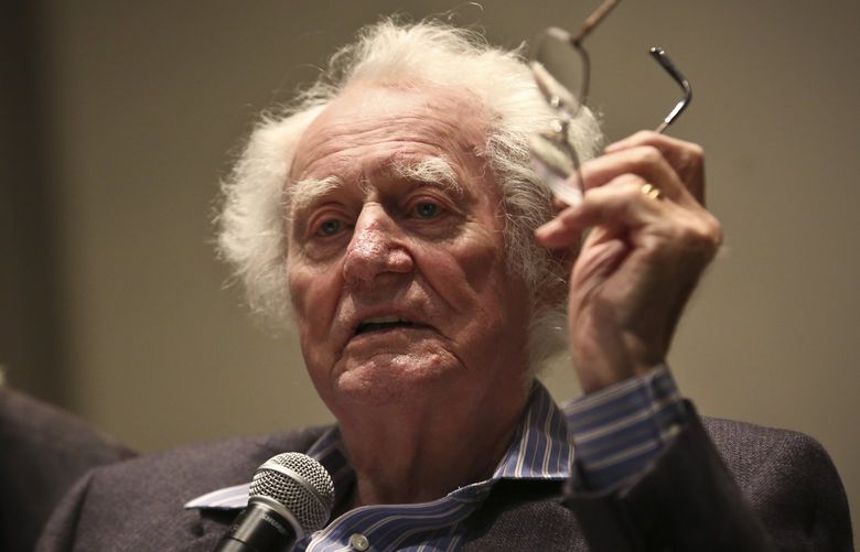 Poet Robert Bly reads from his book “Stealing Sugar from the Castle” at the University of Minnesota on Wednesday, October 16, 2013, in Minneapolis. Holding his microphone is poet Thomas R. Smith. Bly died Sunday, Nov. 21, 2021. He was 94. (Renee Jones Schneider/Minneapolis Star Tribune/TNS) 32924100W 32924100W