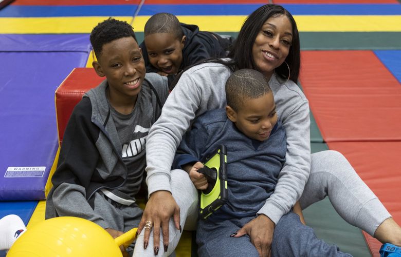 Carneisha Grace, top right, and her sons Josiah Grace, left, Samari Glover, top, and Shawn Glover II at Childhaven in Auburn on Wenesday, November 10, 2021. Carneisha Grace describes being homeless for a six month period prior to receiving services from Childhaven in 2016.  218753
