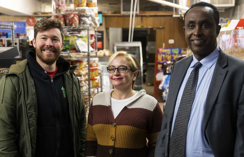 From right, Mohamed Egal, Iris Guzmán and Jake Simpson at Tabarak Minimarket in Seatac on Friday, Nov. 20, 2021. The three progressives unseated conservative city council incumbents during the November election.  218865