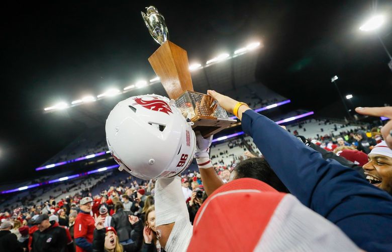 Husky Stadium – Apple Cup – University of Washington Huskies vs. Washington State University Cougars – 112621
The Washington State Cougars hoist the Apple Cup trophy Friday, Nov. 26, 2021, in Seattle. 218907