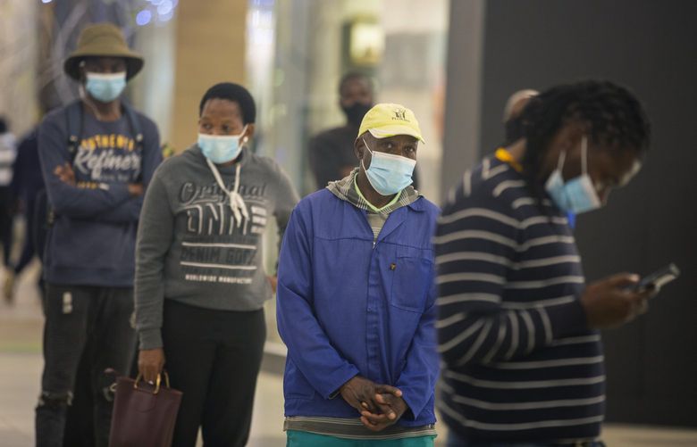 People queue to get vaccinated at a shopping mall, in Johannesburg, South Africa, Friday Nov. 26, 2021. Advisers to the World Health Organization are holding a special session Friday to flesh out information about a worrying new variant of the coronavirus that has emerged in South Africa, though its impact on COVID-19 vaccines may not be known for weeks. (AP Photo/Denis Farrell) XDF102 XDF102
