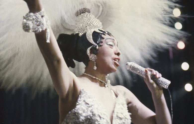 FILE- Entertainer Josephine Baker holds a rhinestone-studded microphone as she performs during her show “Paris, mes Amours” at the Olympia Music Hall in Paris, France, on May 27, 1957. France is inducting Josephine Baker â€“ Missouri-born cabaret dancer, French Resistance fighter and civil rights leader â€“ into its Pantheon, the first Black woman honored in the final resting place of France’s most revered luminaries. (AP Photo, File) XTC103 XTC103