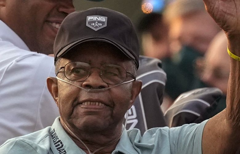 FILE – Lee Elder waves as he arrives for the ceremonial tee shots before the first round of the Masters golf tournament on Thursday, April 8, 2021, in Augusta, Ga. Elder broke down racial barriers as the first Black golfer to play in the Masters and paved the way for Tiger Woods and others to follow. The PGA Tour confirmed Elder’s death, which was first reported by Debert Cook of African American Golfers Digest. No cause or details were immediately available, but the tour said it spoke with Elder’s family. He was 87. (AP Photo/Charlie Riedel, File) NY155 NY155
