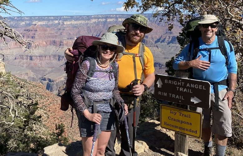 At the southern rim of the Grand Canyon, the O’Connell family from Seattle – from left to right, Lisa, Daniel and Nicholas – celebrate the completion of their four-day trek from rim to rim.