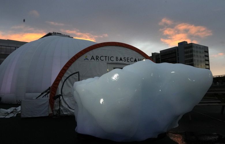 FILE – An iceberg delivered by members of Arctic Basecamp is placed on show near the COP26 U.N. Climate Summit in Glasgow, Scotland, Friday, Nov. 5, 2021. The four ton block of ice, originally part of a larger glacier, was brought from Greenland to Glasgow by climate scientists from Arctic Basecamp as a statement to world leaders of the scale of the climate crisis and a visible reminder of what Arctic warming means for the planet. (AP Photo/Alastair Grant, File) EA108 EA108