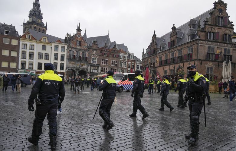 Police patrol the city center after a demonstration against COVID-19 restrictions and lockdown was banned in Nijmegen, eastern Netherlands, Sunday, Nov. 28, 2021. (AP Photo/Peter Dejong) PDJ106 PDJ106