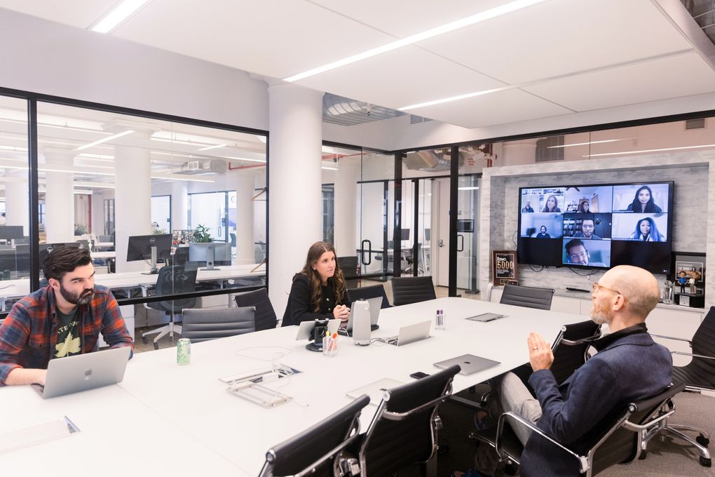Employees meet during a “Work From Work Wednesday” at CommonBond’s office in Manhattan, New York, on Nov. 10. (Jeenah Moon / The New York Times)