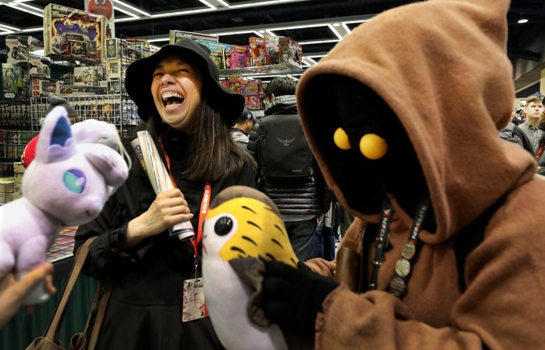 Michaele Razi CQ, left, dressed as a witch from Harry Potter, gets a kick out of Jackie Yeo’s Jawa from Star Wars outfit at Emerald City Comic Con Thursday.  Both wear homemade costumes with peaked tops. Yeo flew in from Anchorage, Alaska during spring break just for the event which runs through Sunday at the Washington State Convention Center.   (They don’t know each other but met on the floor among vendor booths)
Ref to more photos online

LO  First day at Emerald City Comic Con at the Washington State Convention Center
Thursday March 14, 2019 209621