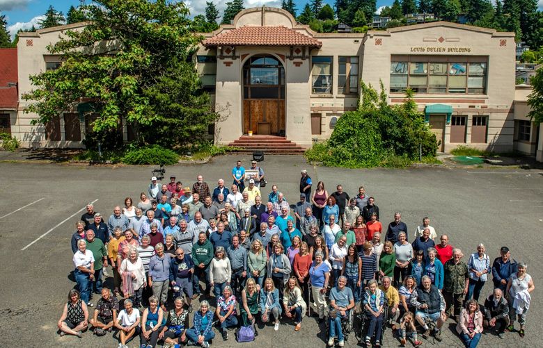 THEN: A total of 109 East Seattle School alumni assemble before the west entry face of East Seattle School on June 8, 2019, to support preservation of the edifice.
