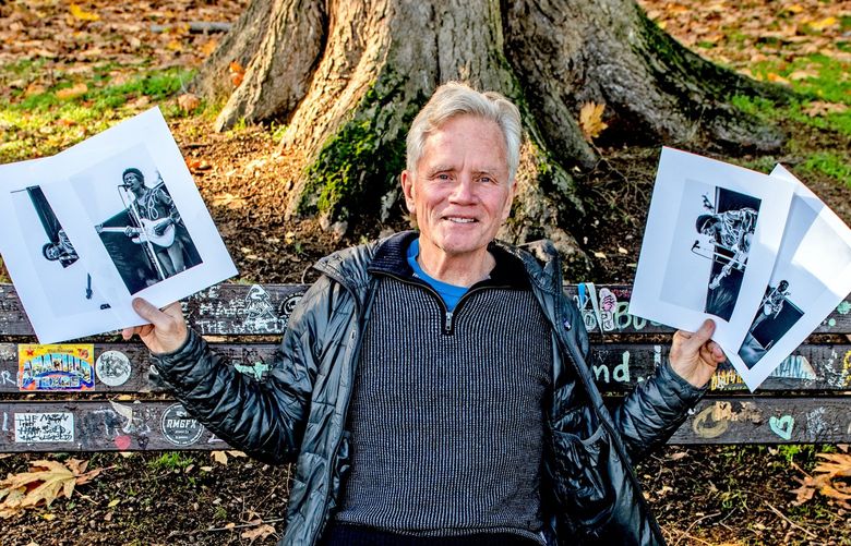 At the Kurt Cobain Memorial Bench in Seattle’s Viretta Park, Wyatt holds a sheaf of the photos he took of Jimi Hendrix at Sicks Stadium. Tragically and coincidentally, both rockers died at 27.