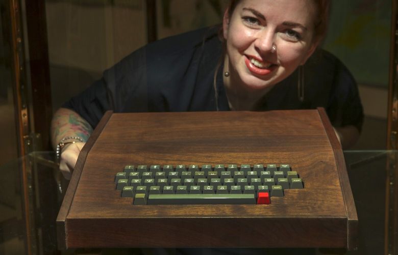 Monrovia, CA – November 06: Original Apple-1 “NTI” motherboard and an Apple Cassette Adapter (ACI) in an original ByteShop Apple-1 koa wood case with Datanetics Keyboard Rev D [keyboard dated: Sept 21 1976]. Morgana Blackwelder with Hand-built Apple-1 displayed for auction at John Moran Auctioneers on Saturday, Nov. 6, 2021 in Monrovia, CA. (Irfan Khan / Los Angeles Times)