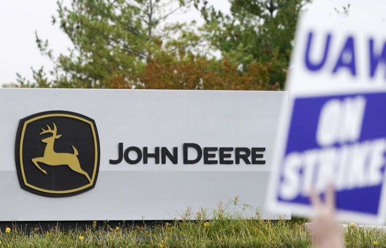 FILE – Members of the United Auto Workers strike outside of a John Deere plant, Wednesday, Oct. 20, 2021, in Ankeny, Iowa.    (AP Photo/Charlie Neibergall, File) 