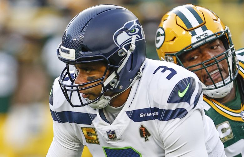 Seattle Seahawks quarterback Russell Wilson (3) runs with the ball during the first half of an NFL football game against the Green Bay Packers, Sunday, Nov. 14, 2021, in Green Bay, Wis. (AP Photo/Kamil Krzaczynski) NYOTK NYOTK