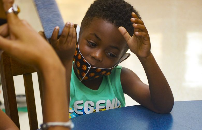 Kaadir, a rising kindergarten student, works with Reading Assist volunteer Jamilah Watson. With support from the state, the tutoring program has expanded to serve students in more than two dozen schools around the state.
