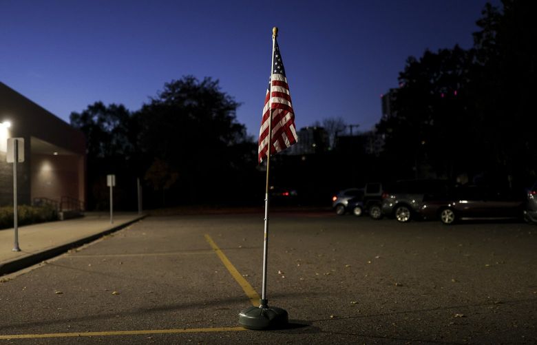 An American flag outside the polling place at Webster Elementary School in Minneapolis on Tuesday, Nov. 2, 2021. Despite signals that things are improving, many Americans seem stuck in a pandemic hangover of pessimism. (Jenn Ackerman/The New York Times) XNYT144 XNYT144