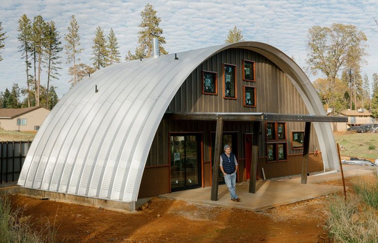Mike Petersen outside a Q Cabin, a 1,400-square-foot structure made from noncombustible steel, in Paradise, Calif., Nov. 3, 2021. After the 2018 Camp Fire destroyed Mike and Jennifer Petersen’s home, they decided to replace it with a Q Cabin. “If there is going to be something that could survive a fire,” Mike Petersen said, “this would be it.” (Jason Henry/The New York Times) XNYT76 XNYT76