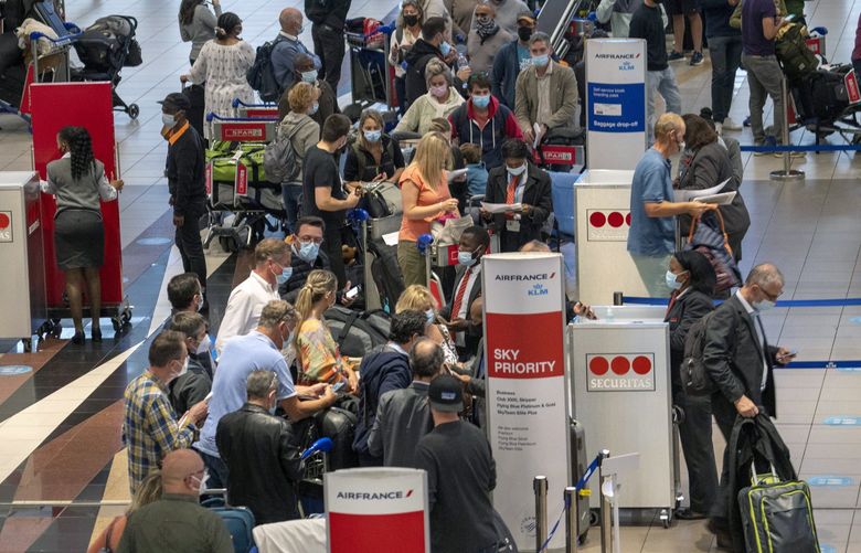 People line up to get on the Air France flight to Paris at OR Tambo International Airport in Johannesburg, South Africa, Friday Nov. 26, 2021. A slew of nations moved to stop air travel from southern Africa on Friday in reaction to news of a new, potentially more transmissible COVID-19 variant that has been detected in South Africa. Scientists say it is a concern because of its high number of mutations and rapid spread among young people in Gauteng, the country’s most populous province. (AP Photo/Jerome Delay) XJD105 XJD105