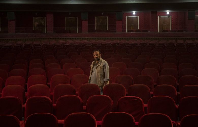 Gul Mohammed, who works as a host in the Ariana Cinema, poses for a photograph in Kabul, Afghanistan, Thursday, Nov. 4, 2021. After seizing power three months ago, the Taliban ordered cinemas to stop operating.(AP Photo/Bram Janssen) XBJ101 XBJ101