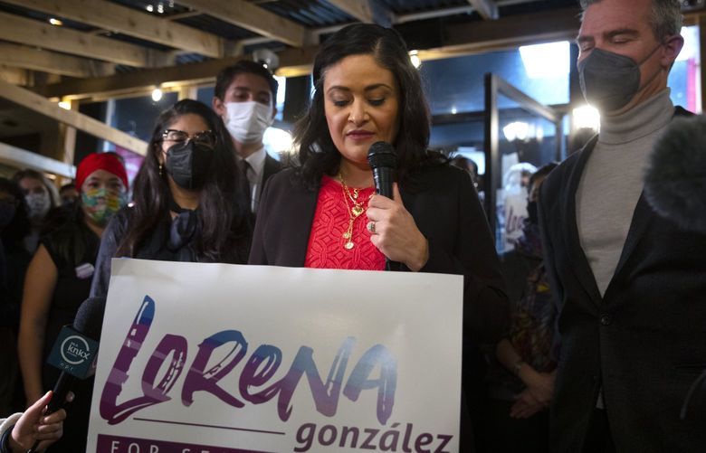 After first early election results were announced, Seattle mayoral candidate M. Lorena González with supporters, including her husband Cameron Williams at right, spoke at her election night party, Tuesday, Nov. 2, 2021 in Seattle. 218701