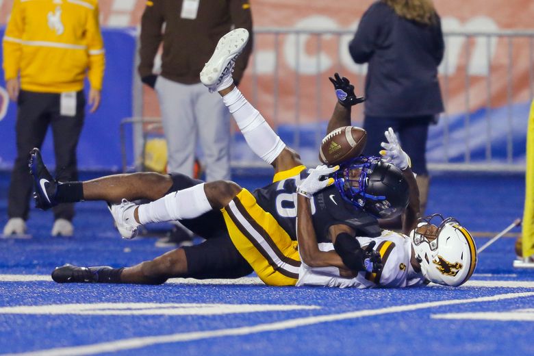 BOISE, ID - NOVEMBER 9: Boise State Broncos (10) Chase Cord (QB) looks for  open receivers during a college football game between the Boise State  Broncos and the Wyoming Cowboys on November