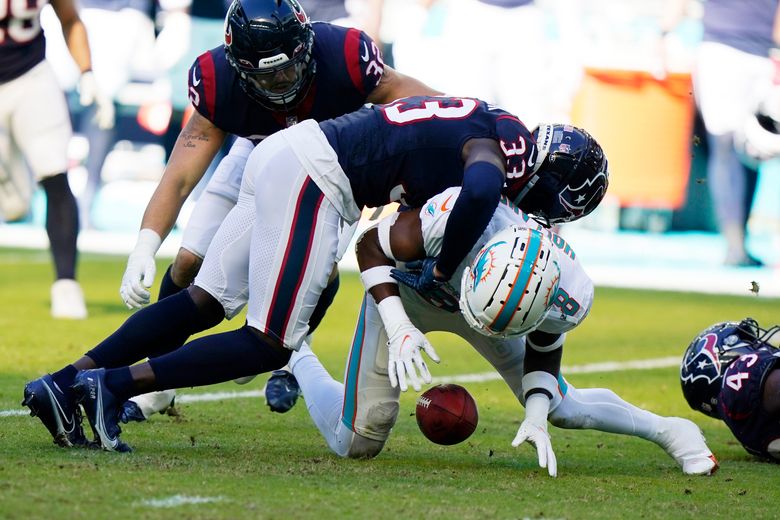 Miami Dolphins safety Jevon Holland (8) enters the field through