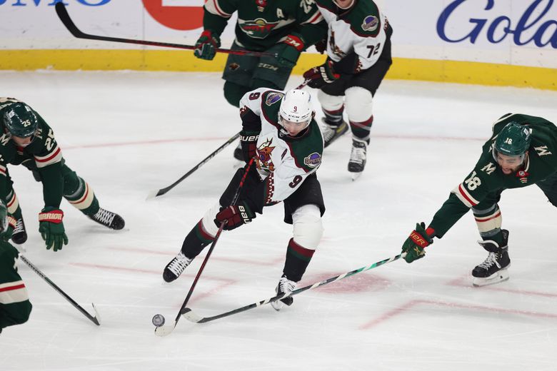 Arizona Coyotes right wing Clayton Keller (9) tries to keep the