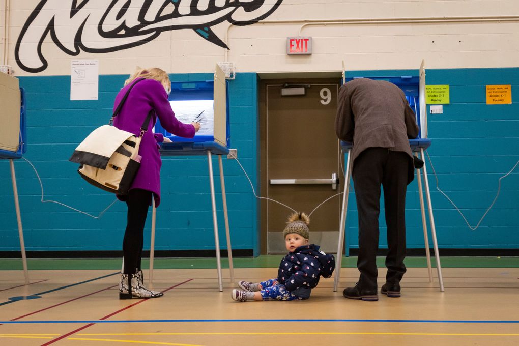 Mayor Jacob Frey casts his vote on Election Day alongside his family at the Marcy Arts Magnet Elementary School on Tuesday, Nov. 2, 2021 in Minneapolis. Voters in Minneapolis are deciding whether to replace the city’s police department with a new Department of Public Safety. The election comes more than a year after George Floyd’s death launched a movement to defund or abolish police across the country. (AP Photo/Christian Monterrosa)