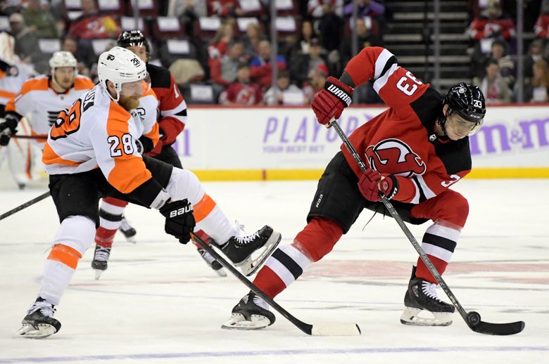 New Jersey Devils defenseman Ty Smith (24) skates with the puck