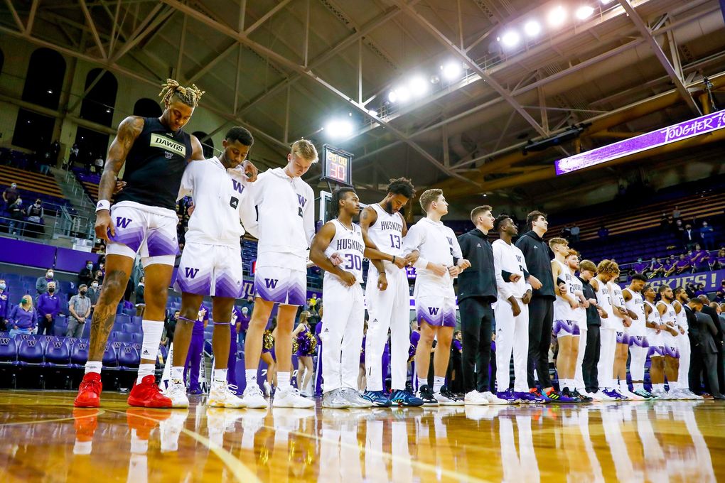 The Washington Huskies line up for the playing of the national anthem before, Nov. 9, 2021, in Seattle. (Jennifer Buchanan / The Seattle Times)
